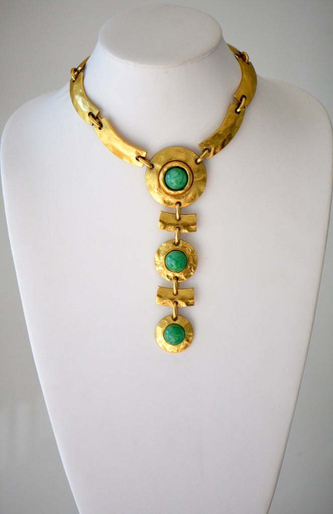 Golden choker with green gem pendant