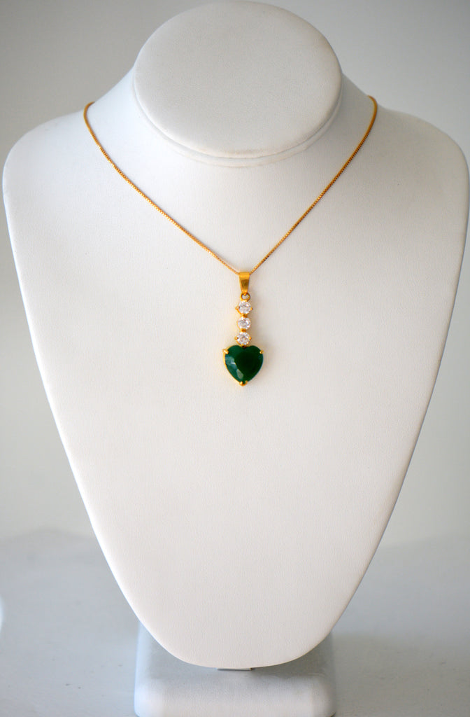 Gold chain with green heart shaped gem